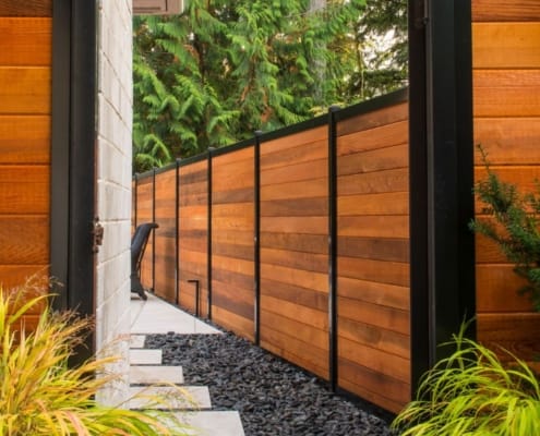 Cedar fence built with black metal posts by Black Post Construction