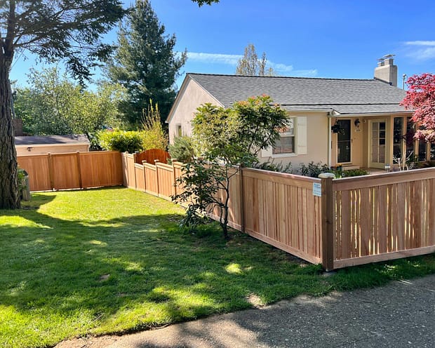 Photo by Jacob Walsh a house with a wooden fence in front of it