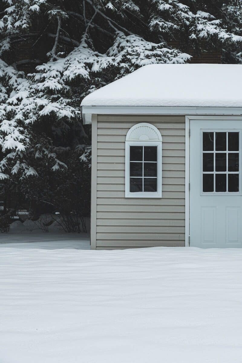 white wooden house covered with snow